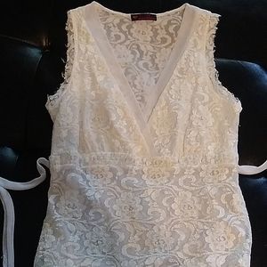"FIRST KISS" top,ivory in color with lacy overlay,ties at the back.size M